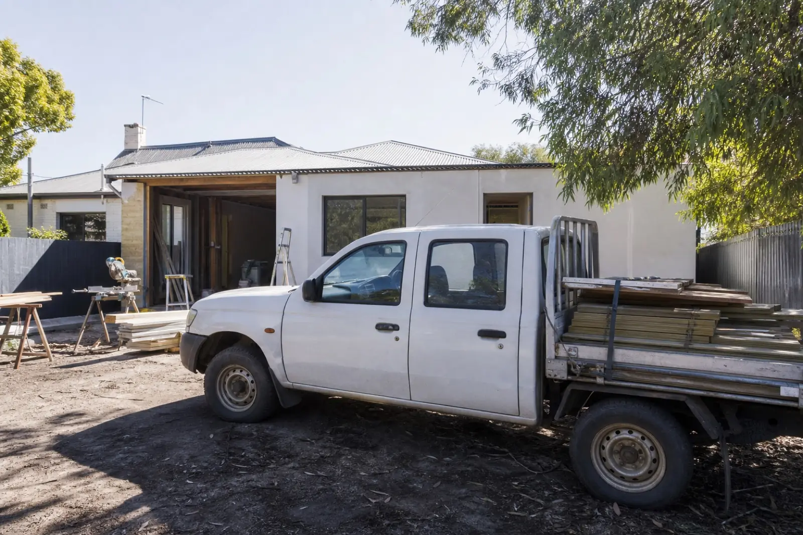 A builder's ute beside a small suburban job